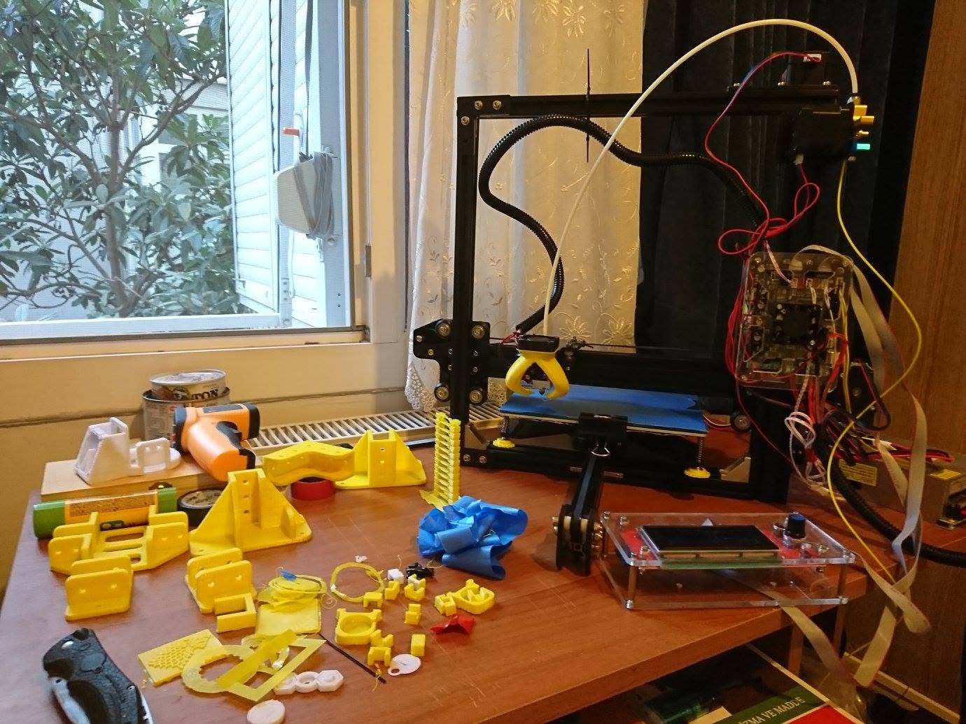 Yellow parts printed for the Tevo Tarantula, spread across the desk